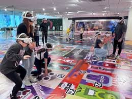 Visitors walking across a large XR play space.